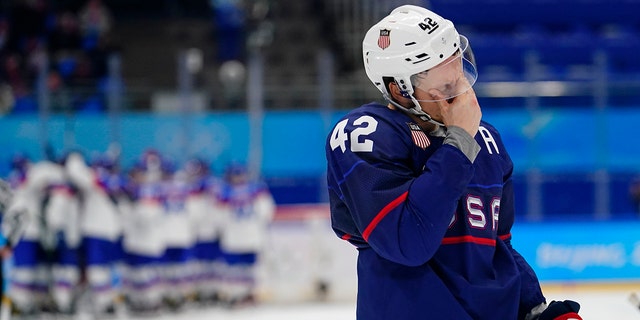 United States player Aaron Ness (42) leaves the ice as Slovakia players celebrate behind him after their men's quarter-final hockey game at the 2022 Winter Olympics on February 16, 2022 in Beijing.  Slovakia won 3-2 on penalties.