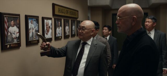 Mallory displays the NASA Apollo Astronauts exhibit of a visiting Chinese scientist who is a denier of the moon landing.