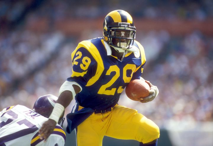 Eric Dickerson dribbling the ball at the height of the NFL with the Rams.