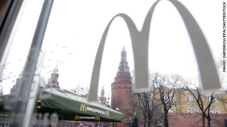 People walk outside a McDonald's restaurant on Manzhnaya Square in Moscow, Russia in April 2014.